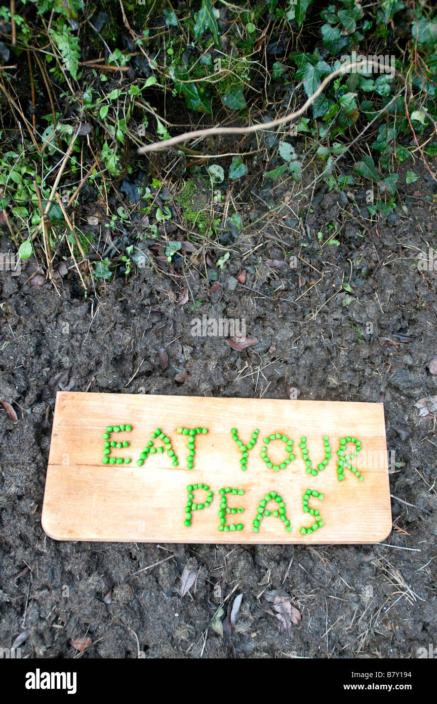Eat your peas spelt out in peas on a chopping block Stock Photo Alamy