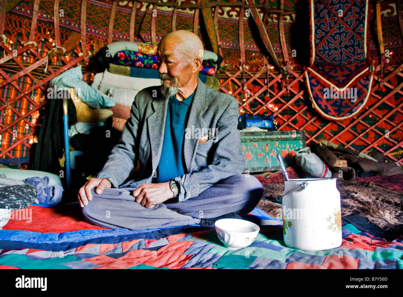 Old Kyrgyz man drinking horse milk inside his yurt Kyrgyzstan Stock Photo