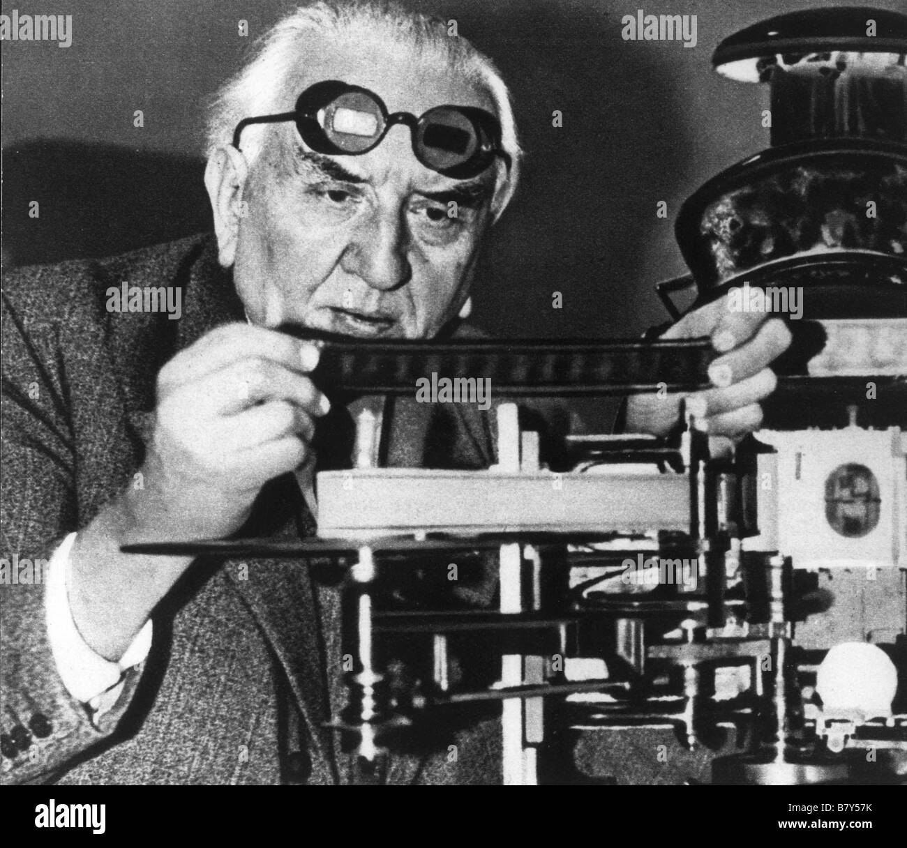Louis Lumière, special glasses on  forehead, before his camera for screening in 3D Stock Photo