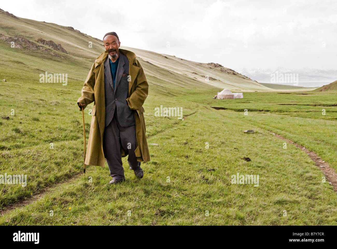 Old Kyrgyz shepherd walking near his yurt Song Kol lake Kyrgyzstan Stock Photo