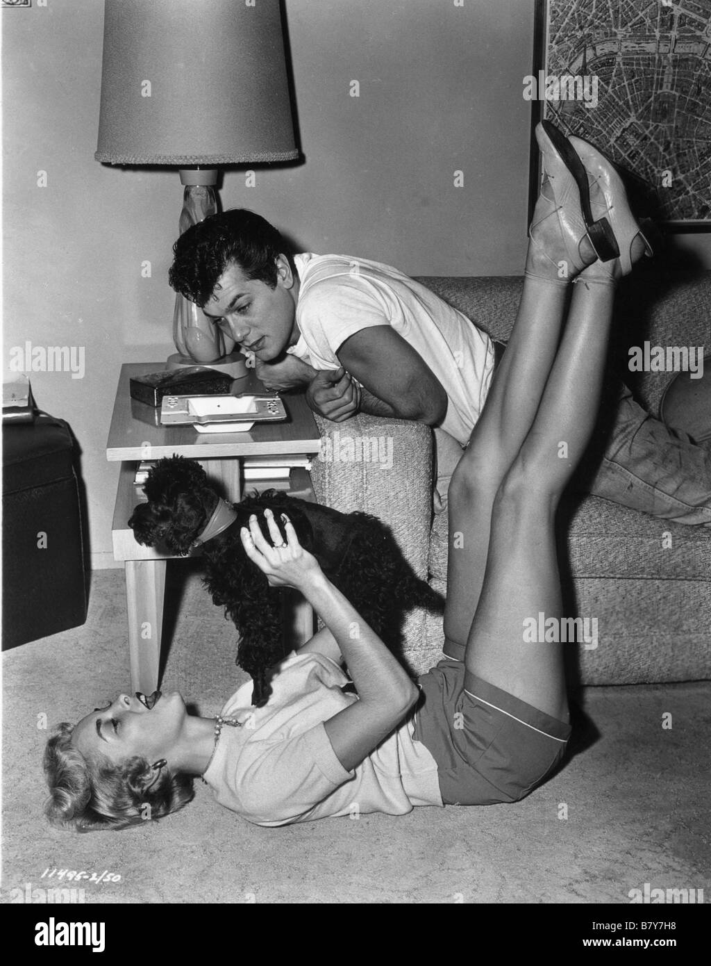 Tony Curtis, Janet Leigh having a moment of distraction while taking the film Houdini  Year: 1953 USA Stock Photo