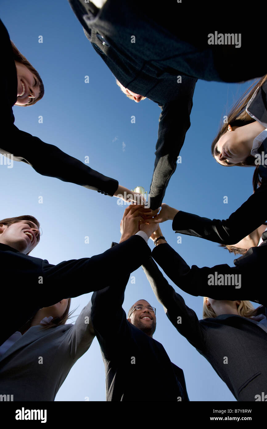 Group in business attire giving cheer Stock Photo Alamy