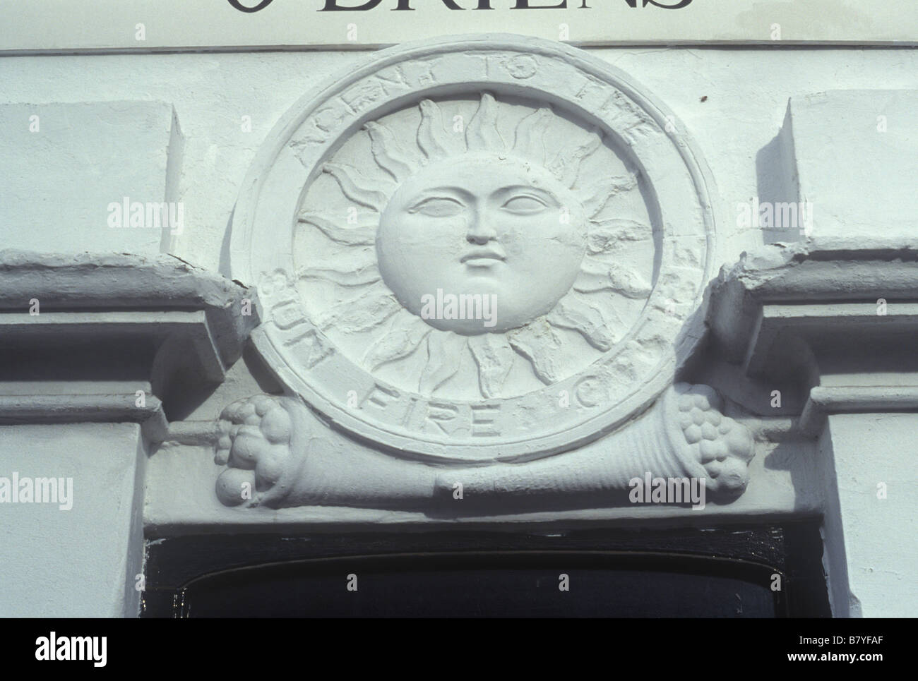 Camden Town North London UK. Victorian stucco trade sign Agent for the Sun Fire Office image of sun with face and sunrays Stock Photo