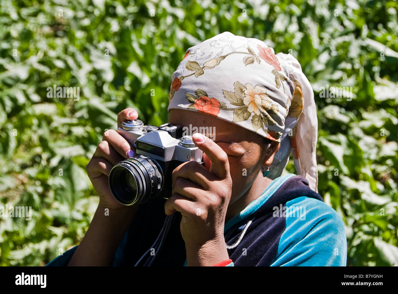 Kyrgyz woman with camera near her yurt Kyrgyzstan Stock Photo