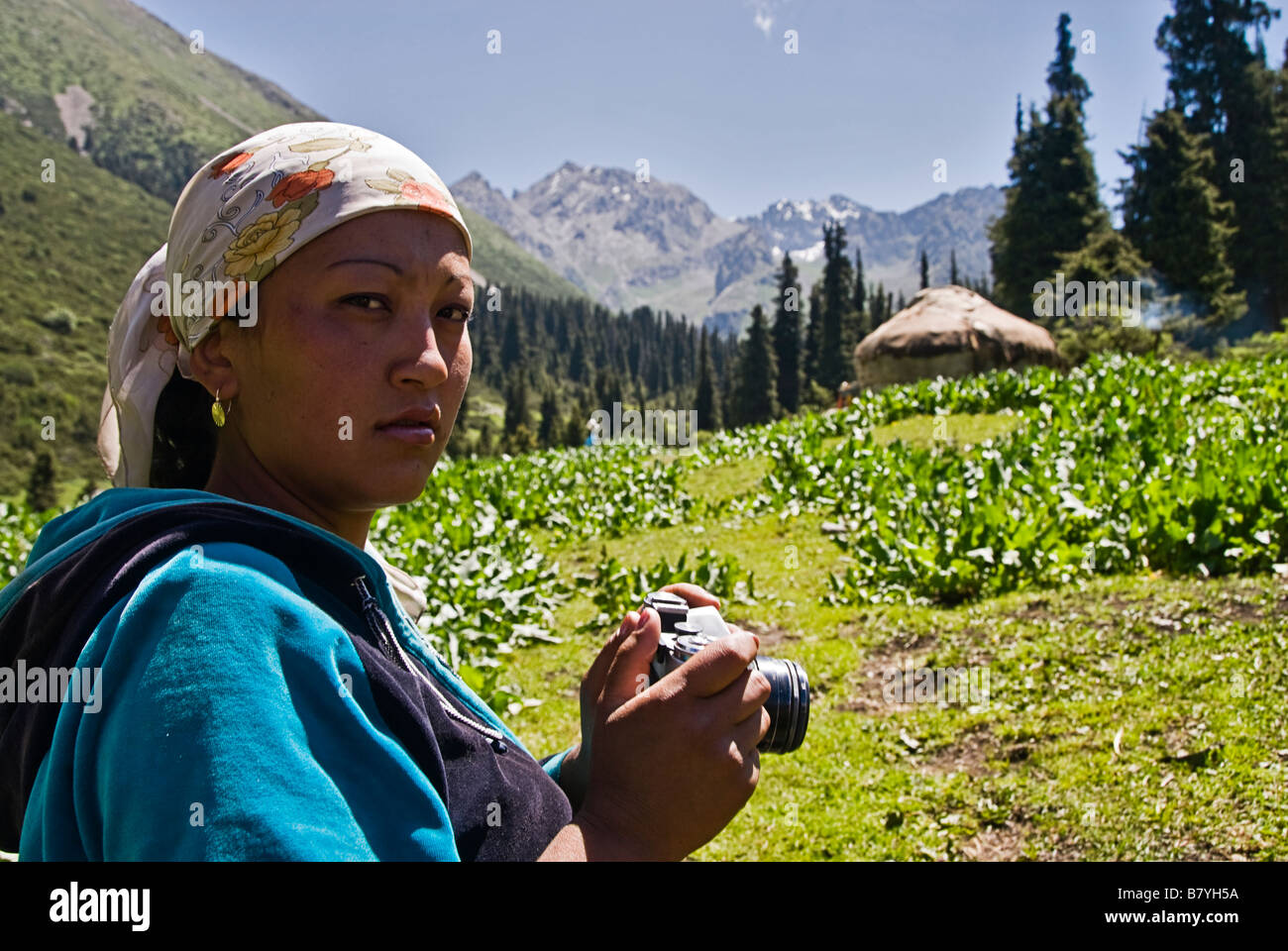 Kyrgyz woman with camera near her yurt Kyrgyzstan Stock Photo