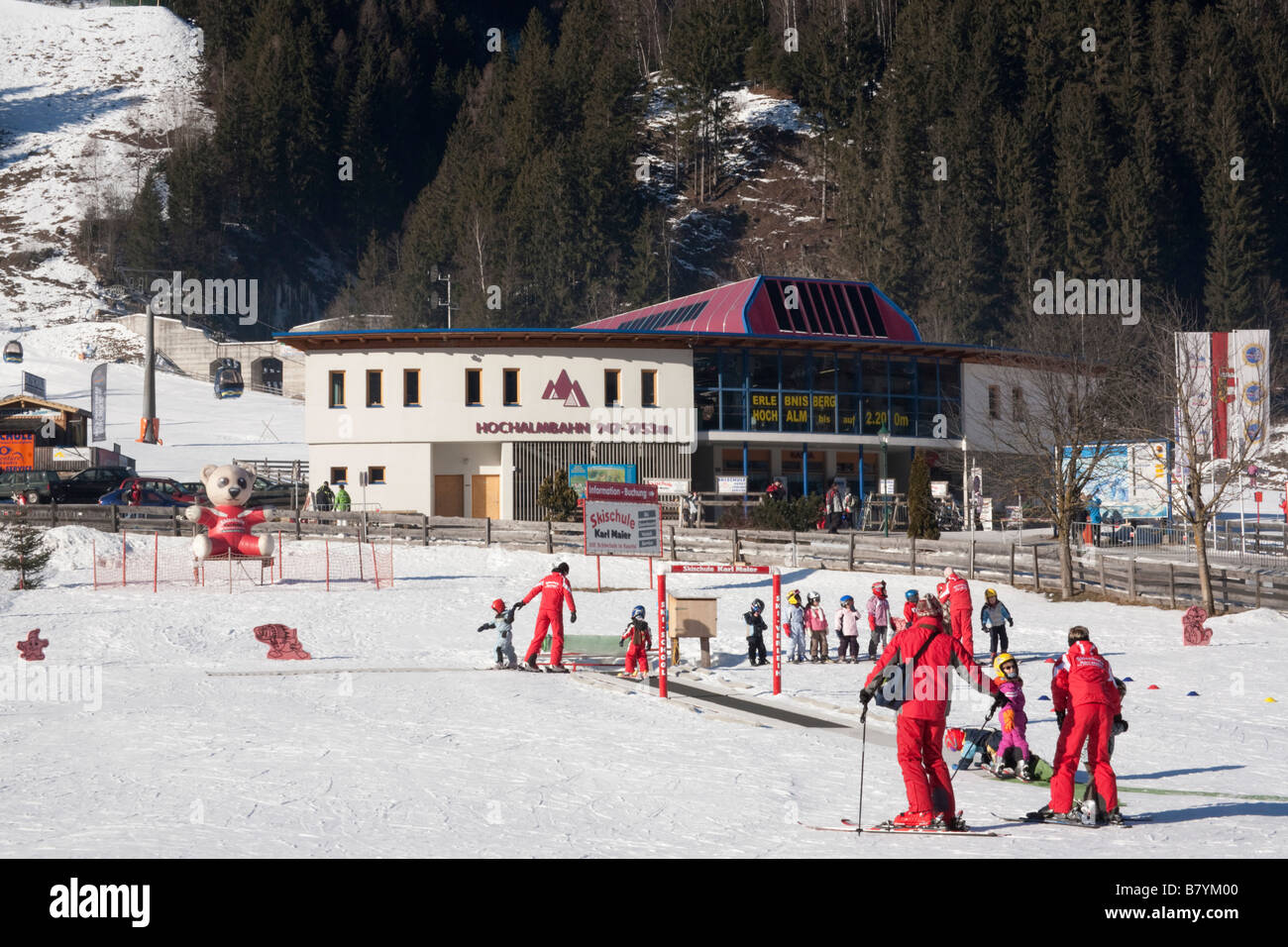 Children learning on ski school nursery slopes in Alpine resort in Austrian Alps in winter snow. Rauris Austria Europe Stock Photo