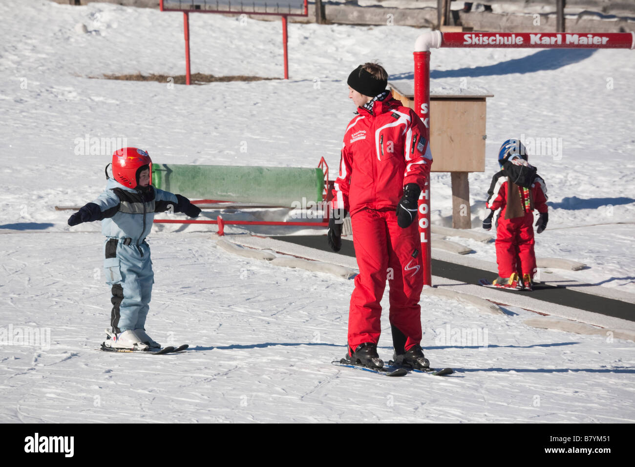 Rauris Austria Europe  Children learning to ski on ski-school nursery slopes in winter snow Stock Photo