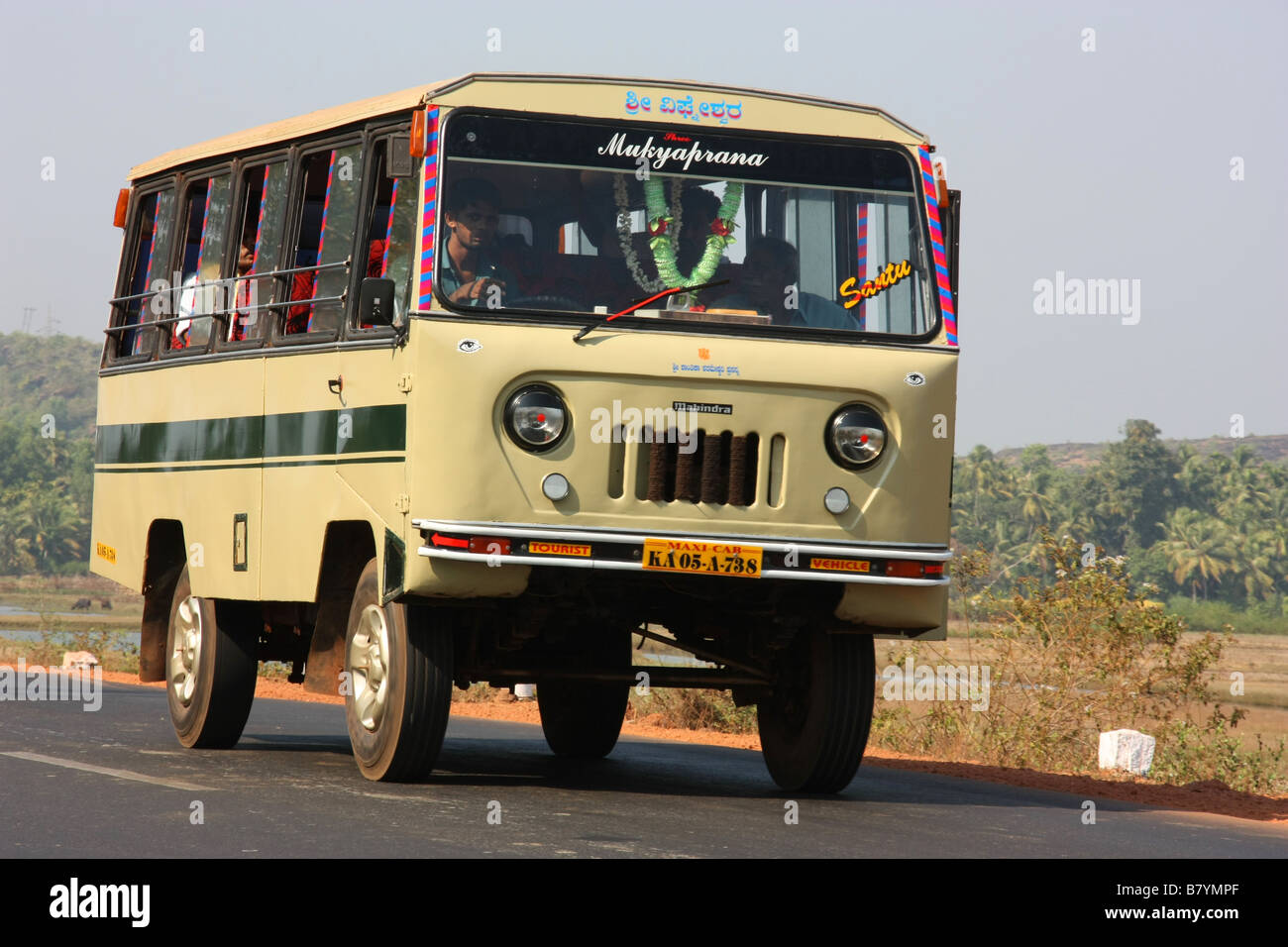 Mahindra mini bus at speed in rural Karnataka India Stock Photo