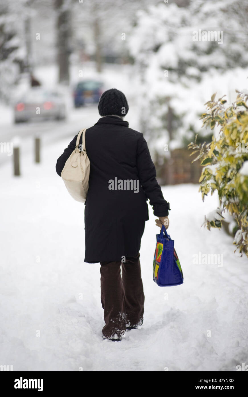 Woman walking snow lane winter hi-res stock photography and images - Alamy