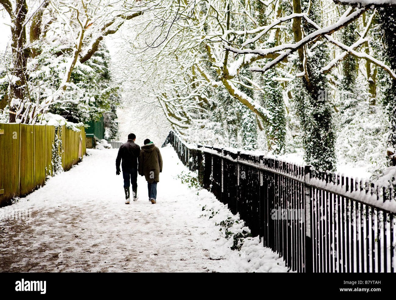 Couple Walking On Hampstead Heath In The Snow London UK Europe Stock Photo