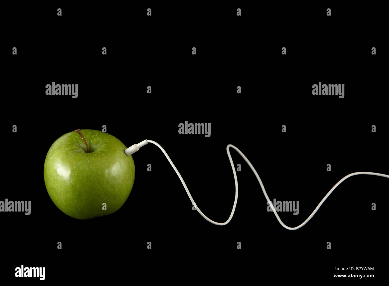 Apple with a white headphone cord Stock Photo Alamy