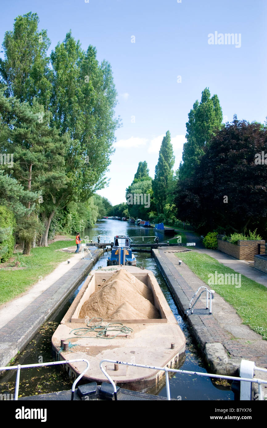 Loaded working barge or narrowboat full of ballast on canal in denham