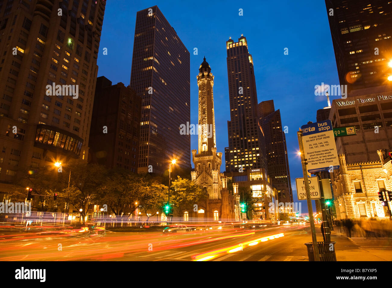 ILLINOIS Chicago Water Tower building on Michigan Avenue at dusk CTA bus stop sign Water Tower Place Stock Photo