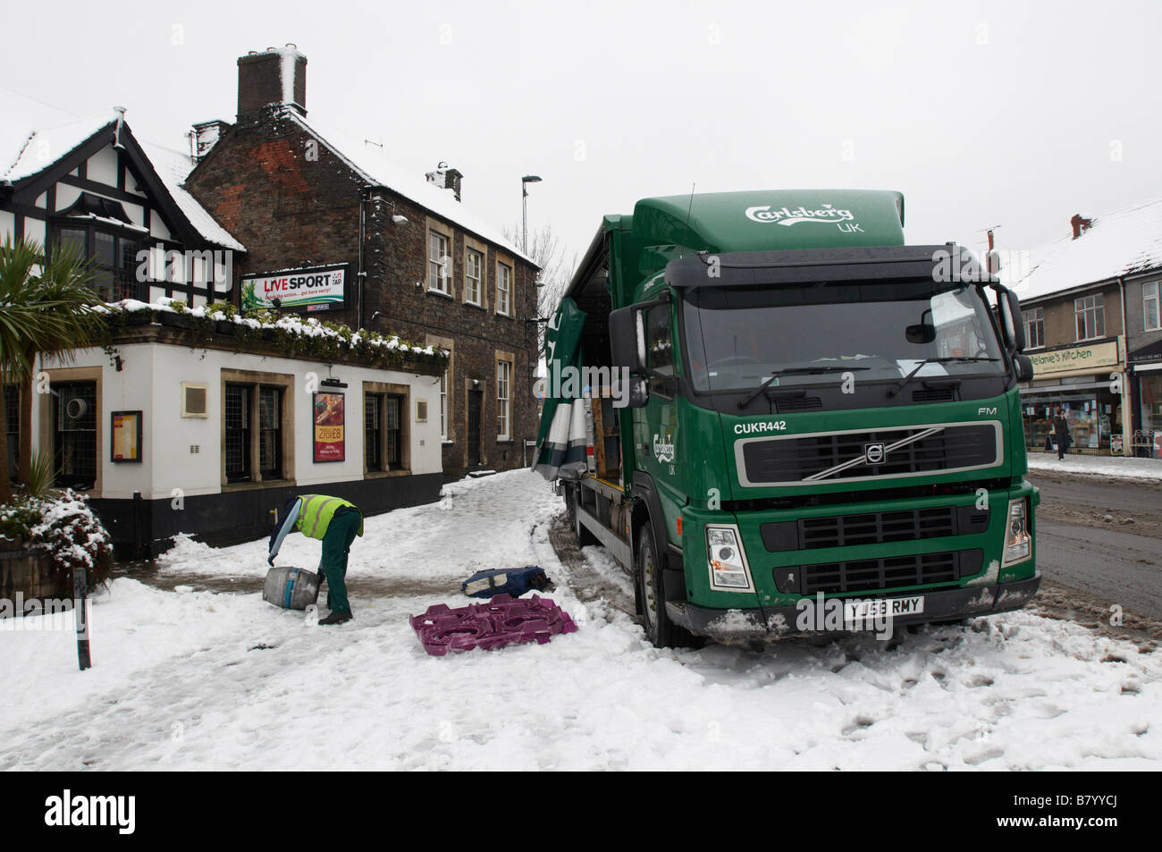 Carlsberg delivery lorry truck to a local pub in Downend Bristol in snow winter Stock Photo