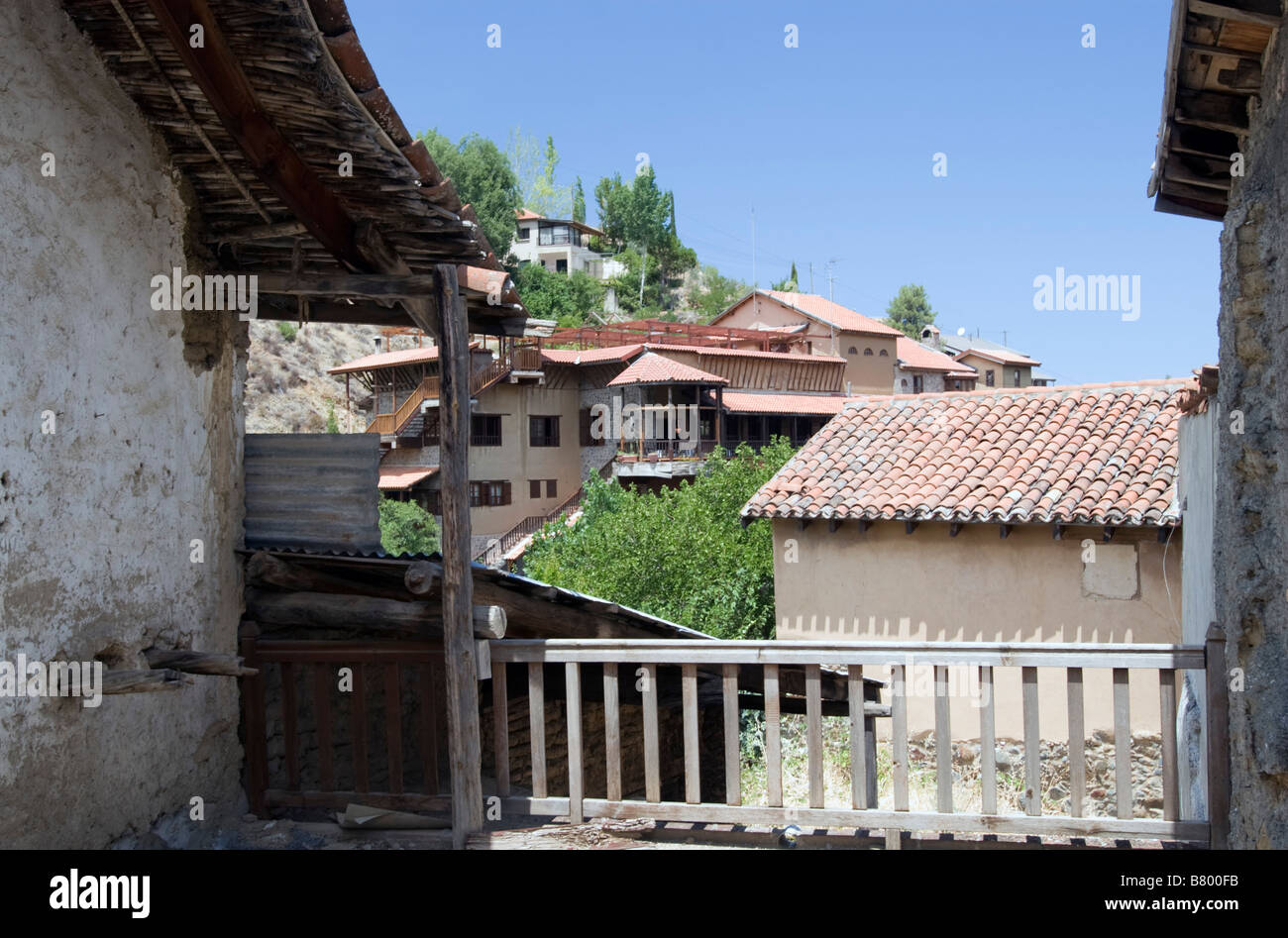 Tiled roof view on foreground and mountains with homes on background in Kakopetria village in Troodos mountains South Cyprus Stock Photo