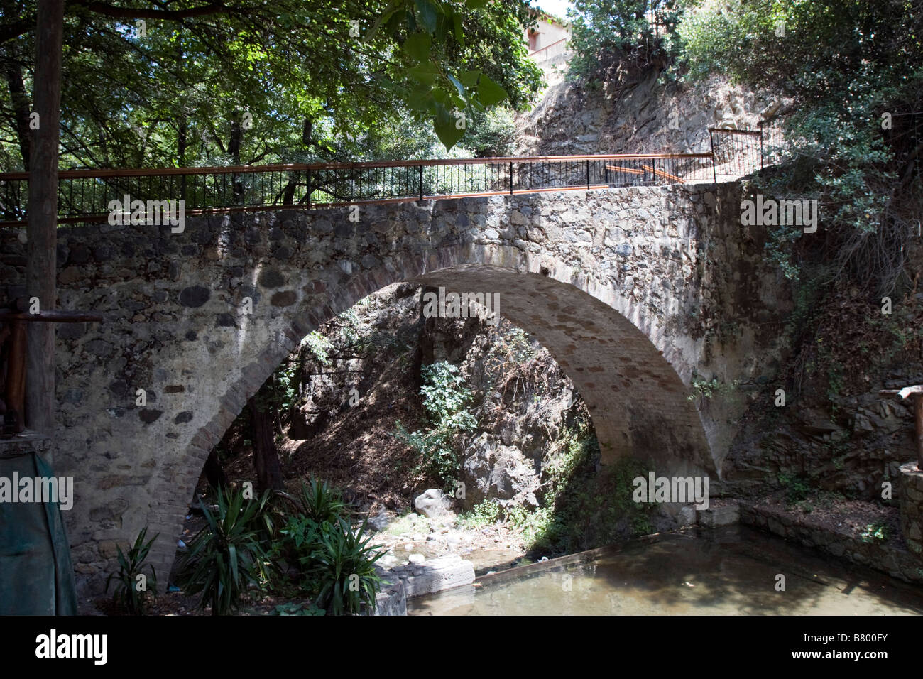 Old stone arche bridge over mountain river in Kakopetria village in ...