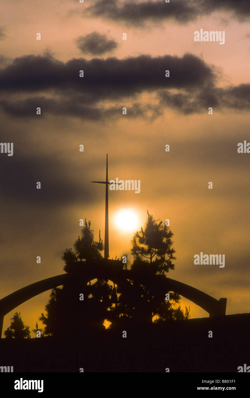 Sunset behind cross on top of church Stock Photo