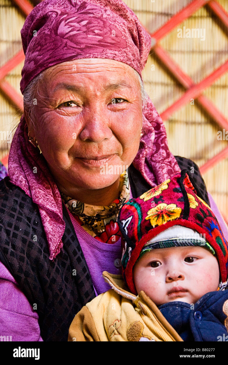 Kyrgyz grandmother and kid in a yurt Near Irkestan pass Kyrgyzstan Stock Photo