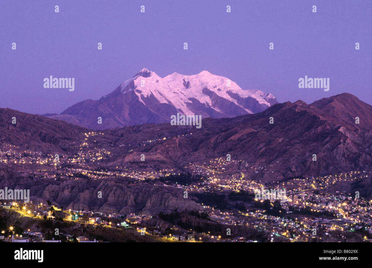Lights of suburbs in Zona Sur part of city and Mt Illimani at sunset, La Paz, Bolivia Stock Photo