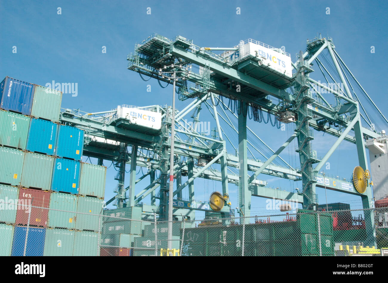 Cargo carriers loading and unloading a group of cargo containers Stock ...