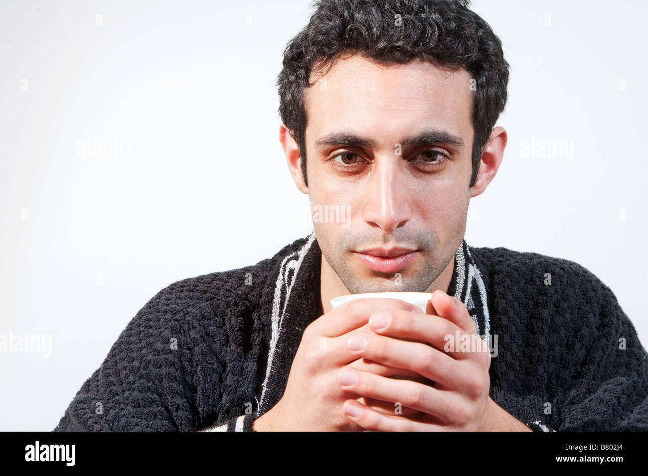Tiring Robe Tired handsome man with a mug wearing a black robe isolated Stock Photo ...
