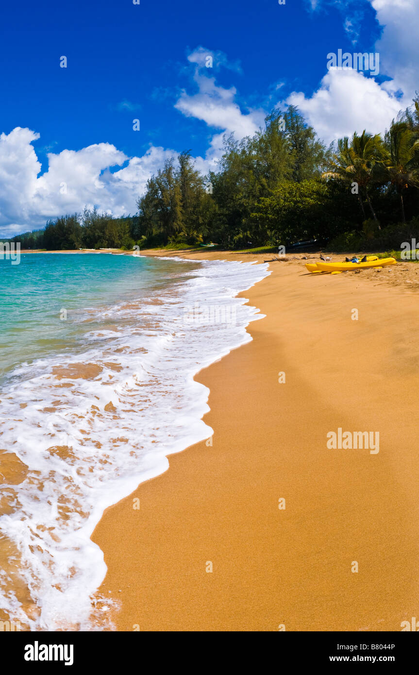 Kayaks on empty beach at Hanalei Bay Island of Kauai Hawaii Stock Photo