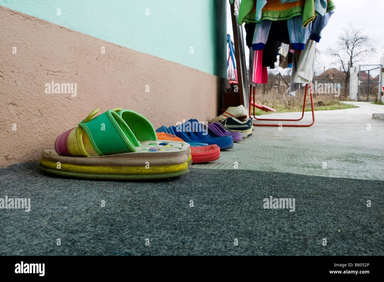 Childrens footwear outside a Romanian orphanage or placement centre in the village of Tinca Stock Photo