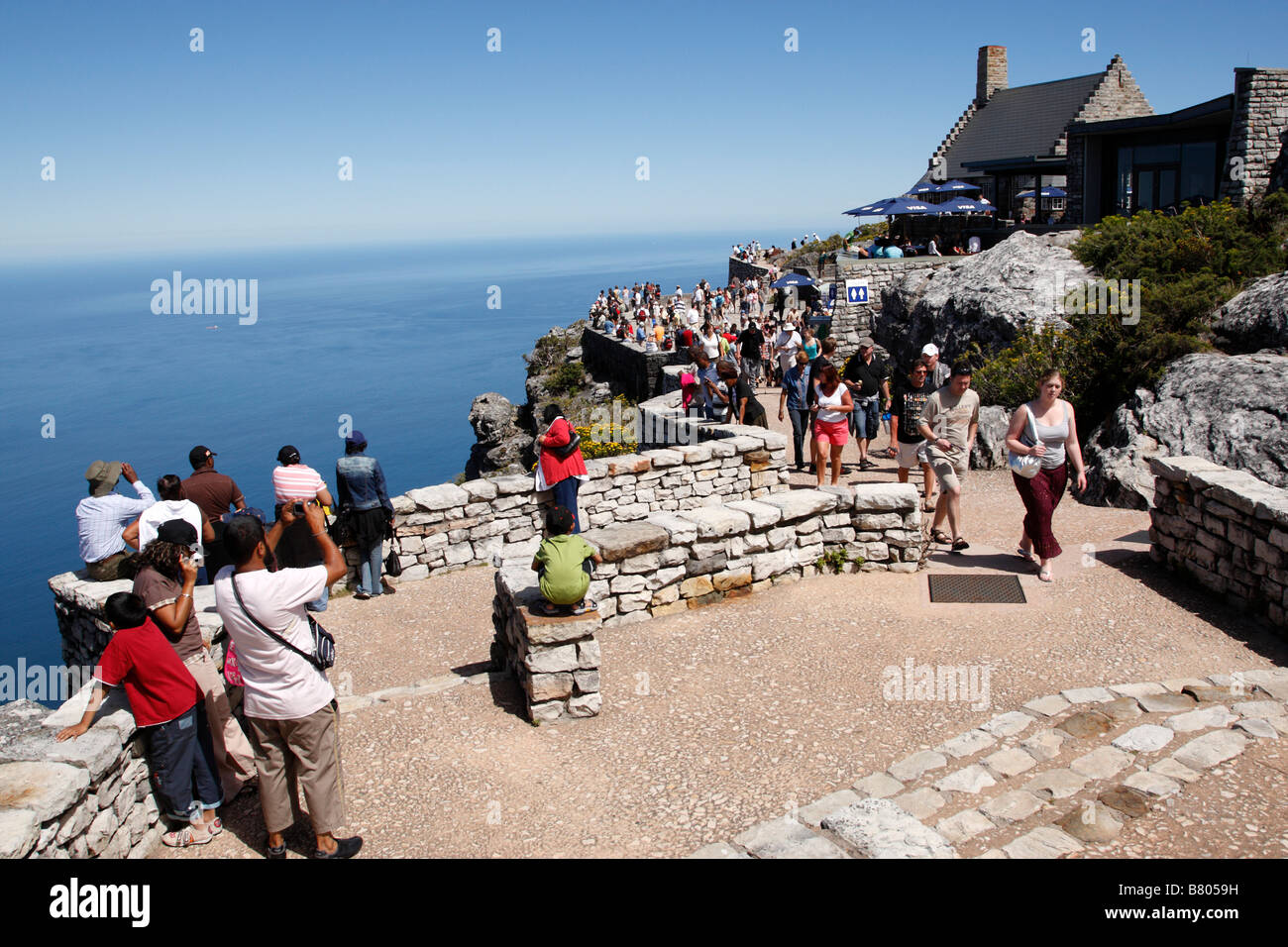 tourists admire the views on twelve apostles terrace from the top of table mountain cape town south africa Stock Photo