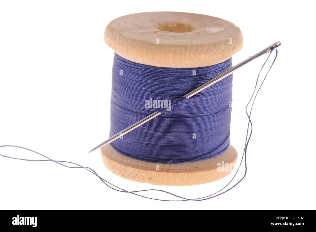 spool of thread and sewing needle isolated on white background Stock Photo