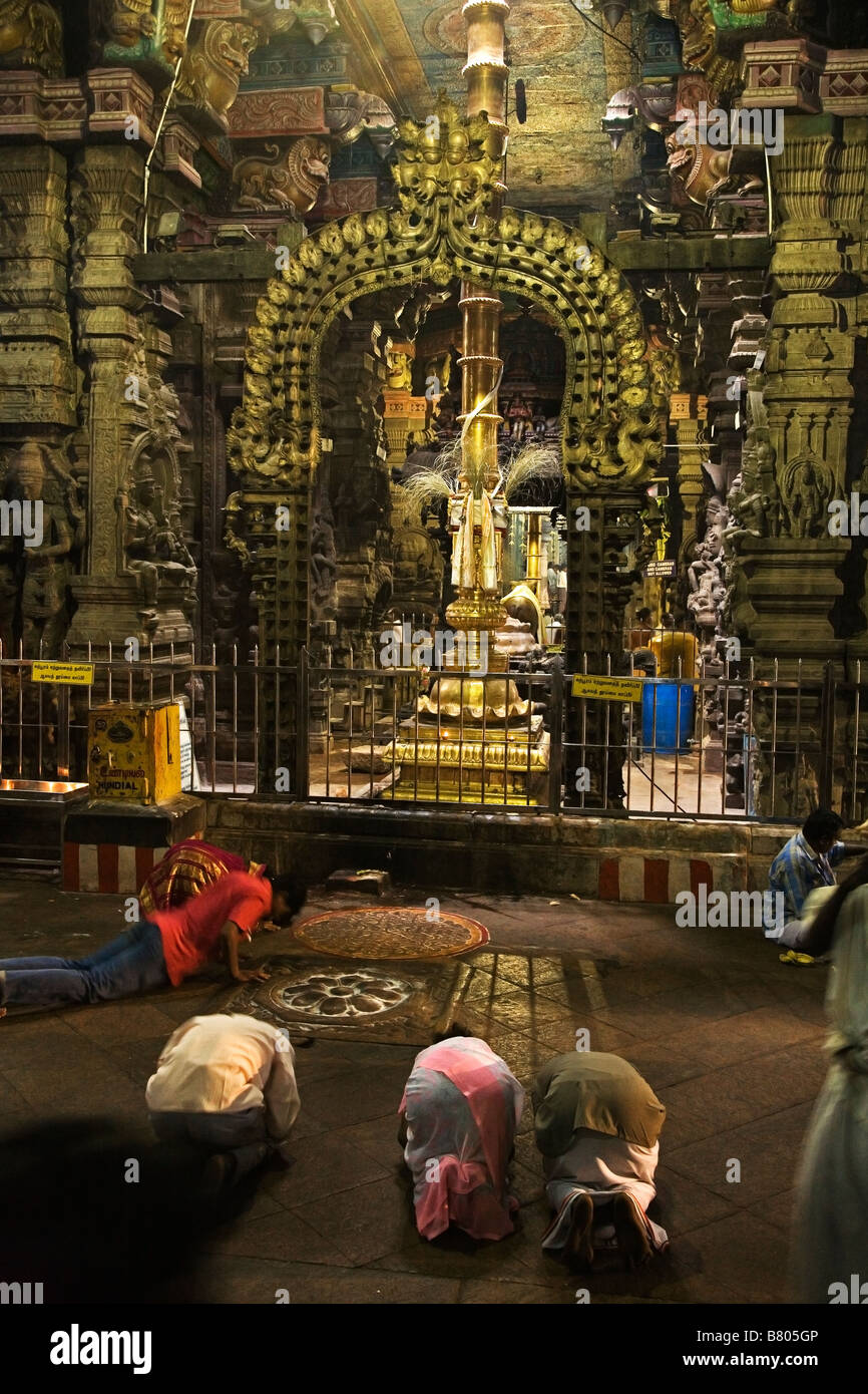 Pilgrims praying in front of the main shrine at Shree Meenakshi Temple in Madurai in Tamil Nadu India Stock Photo