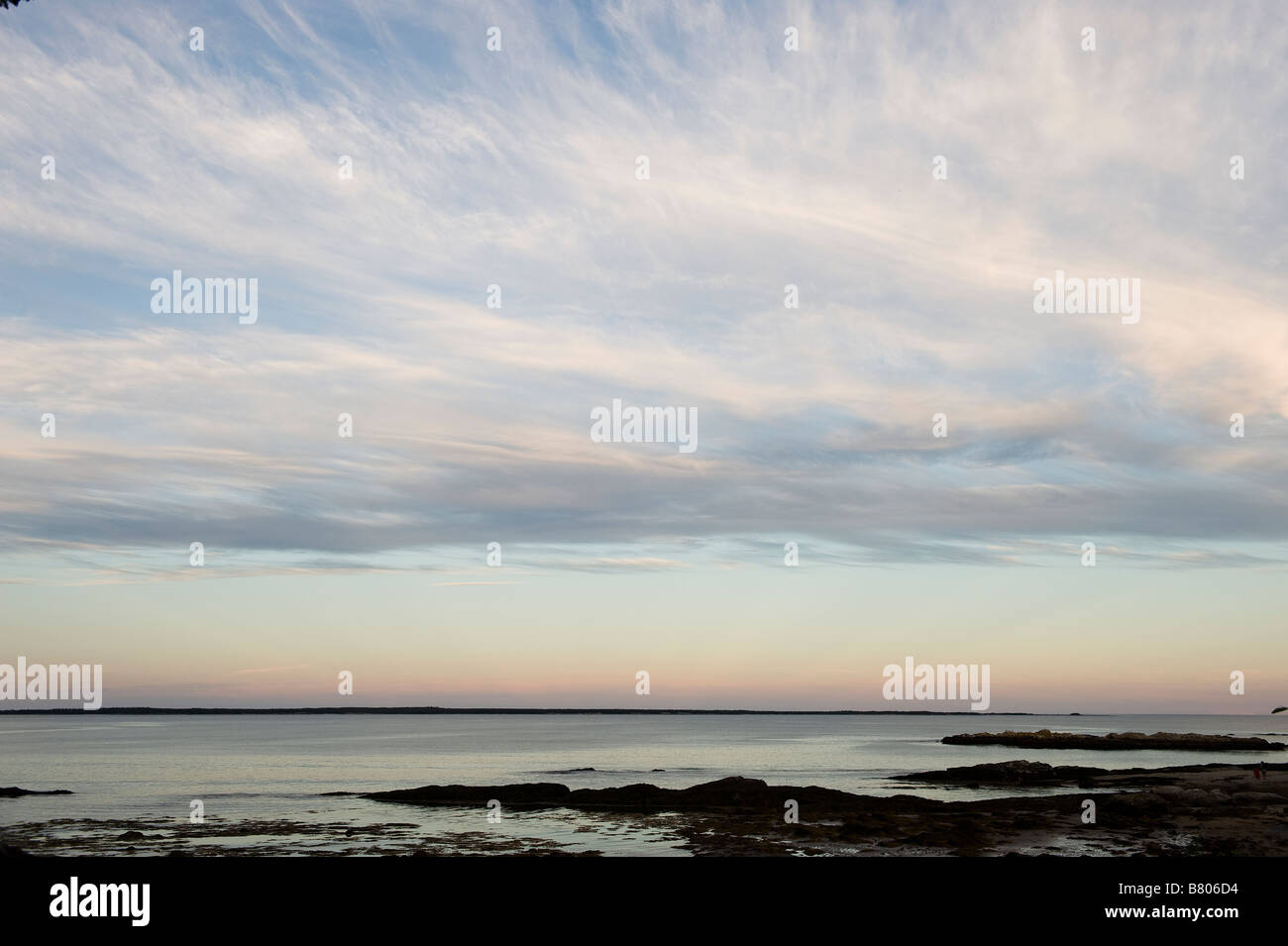 A beautiful pink blue sky sunset over a peaceful ocean Stock Photo - Alamy