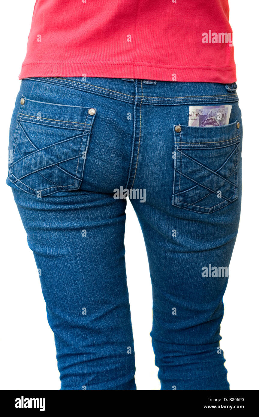 Back View Of A Person Woman wearing Blue Jeans Denims With a 20 Note in Her Rear Pocket Stock Photo
