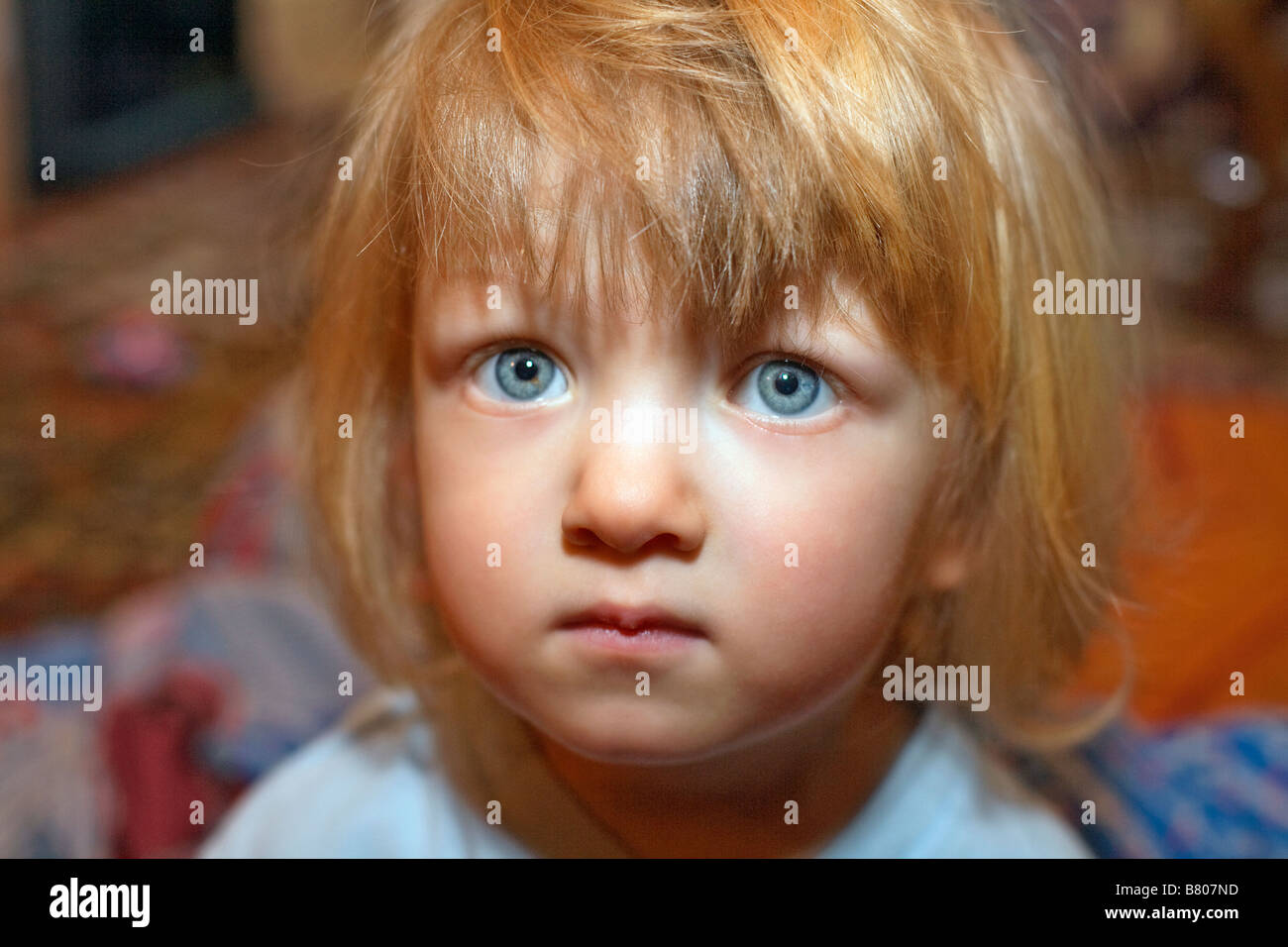 TWO YEAR OLD BOY WITH LONG HAIR AND BIG EYES Stock Photo