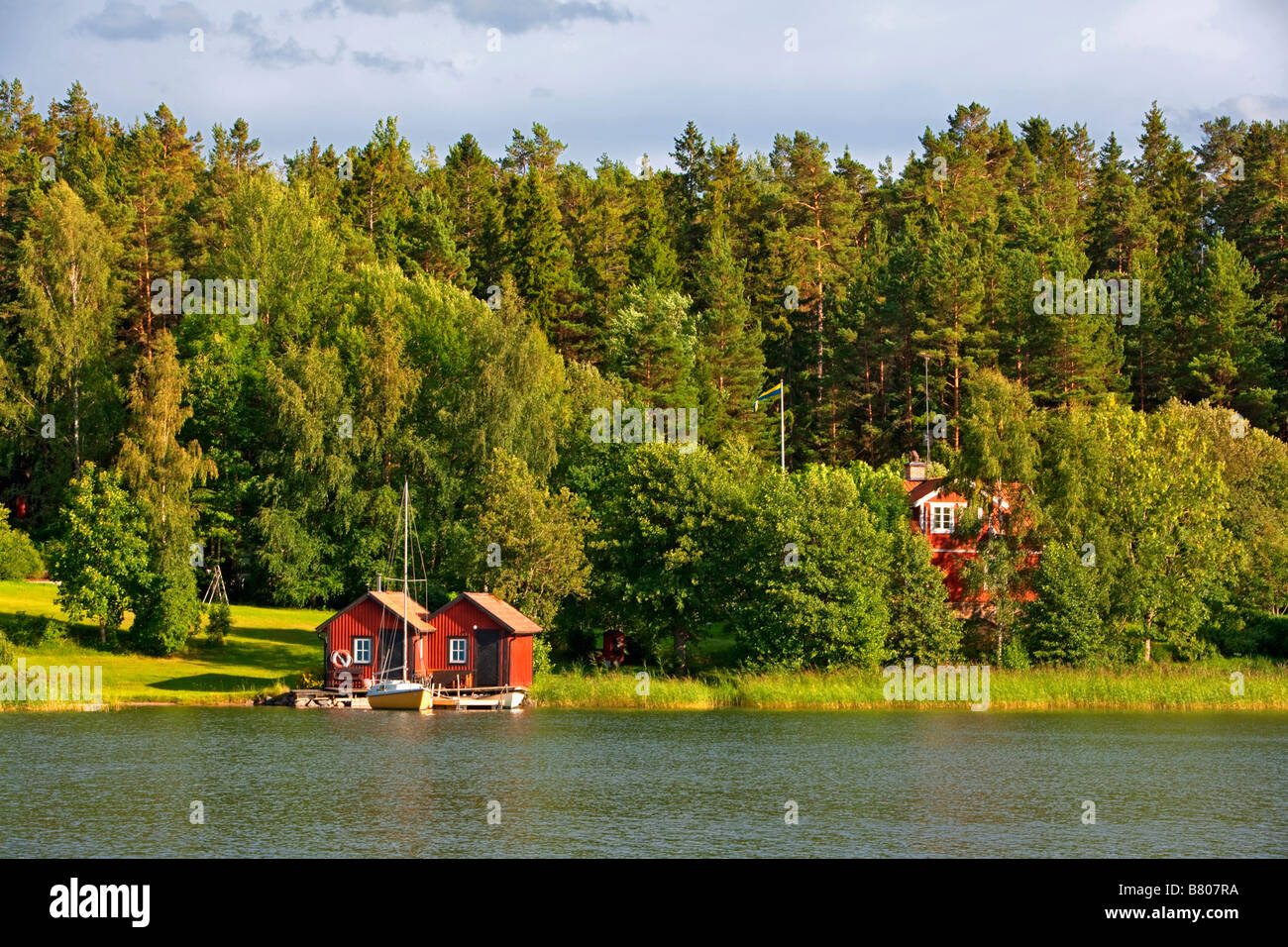 SWEDEN STOCKHOLM ARCHIPELAGO TRADITIONAL RED HOUSE AND BOATHOUSE ON AN