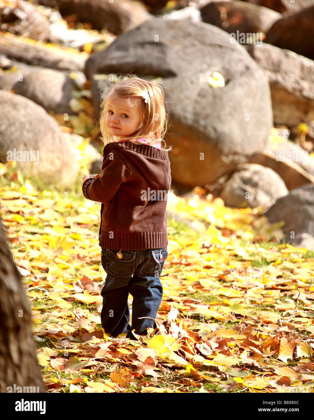 Young girl in park in autumn Stock Photo - Alamy