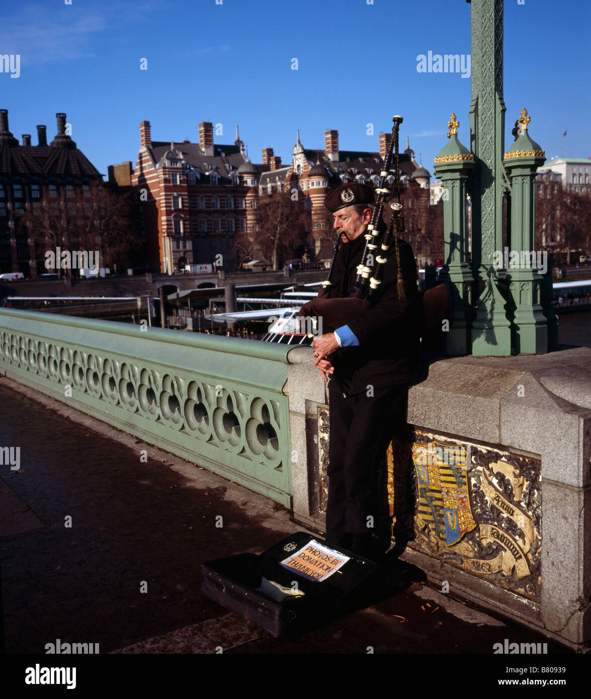 Man playing the bagpipes on Westminster Bridge London England UK Stock Photo