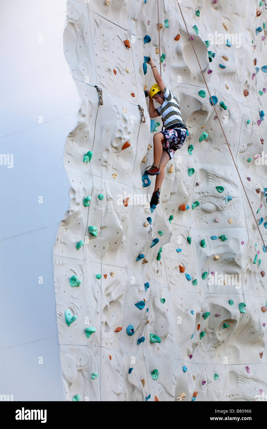 Teenage boy climbing artificial rock wall onboard Royal Caribbean ...