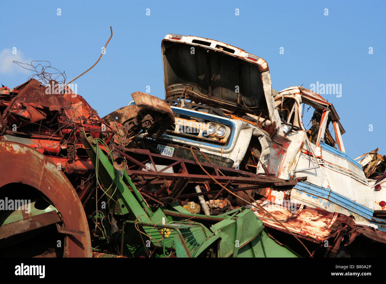 Wrecked vehicles and machinery in a junkyard salvage operation Stock