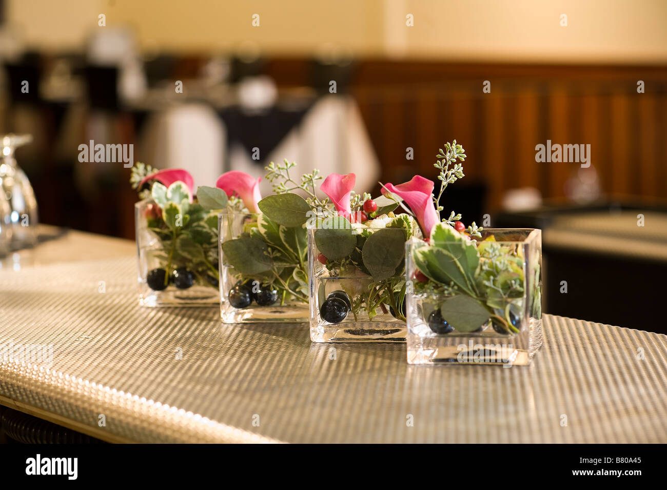 Small Glass Vases Holding A Beautiful Floral Arrangement Stock