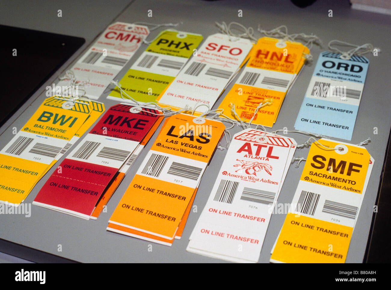 Luggage tags for different cities rest on counter at airport