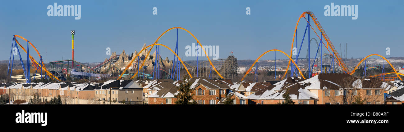 Panorama of a closed amusement park Wonderland roller coaster in winter next to a residential housing development near Toronto Stock Photo
