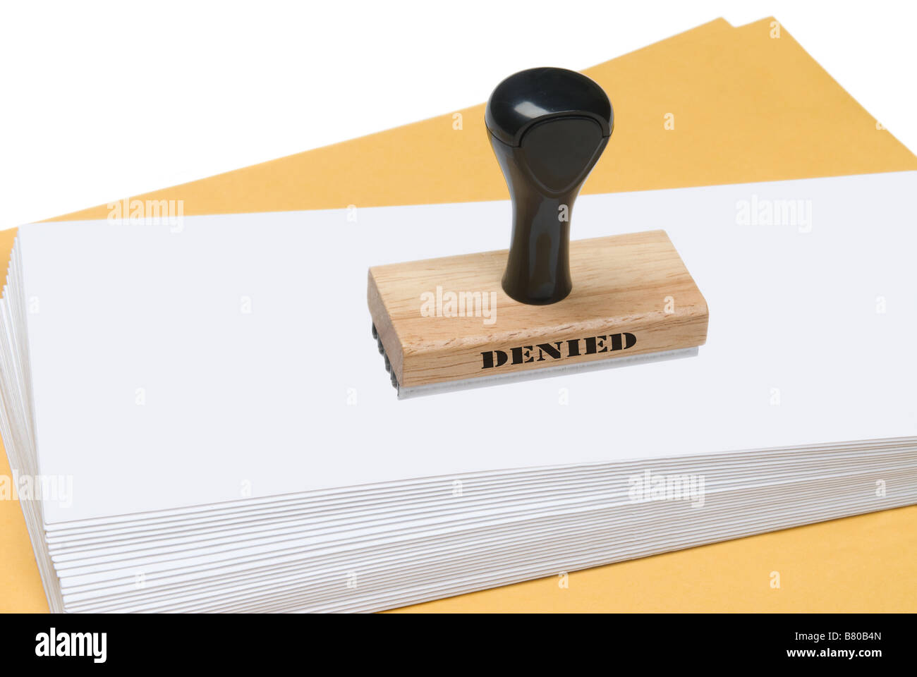 A denial rubber stamp on envelopes ready to send a message Stock Photo