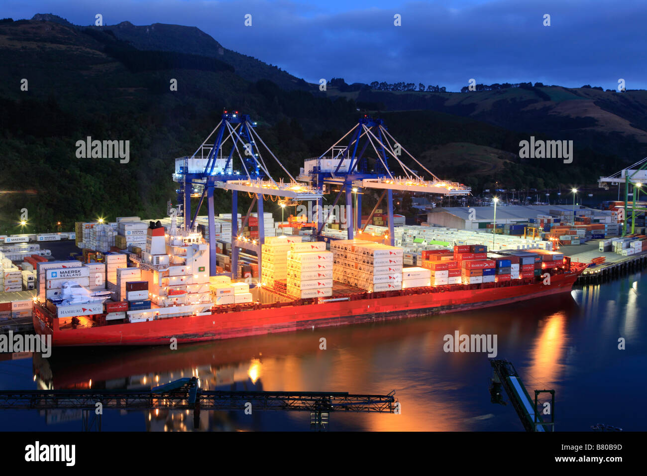 Sea Container ship docked at terminal at night,Port Chalmers, Otago Harbour, Dunedin, South Island, New Zealand Stock Photo