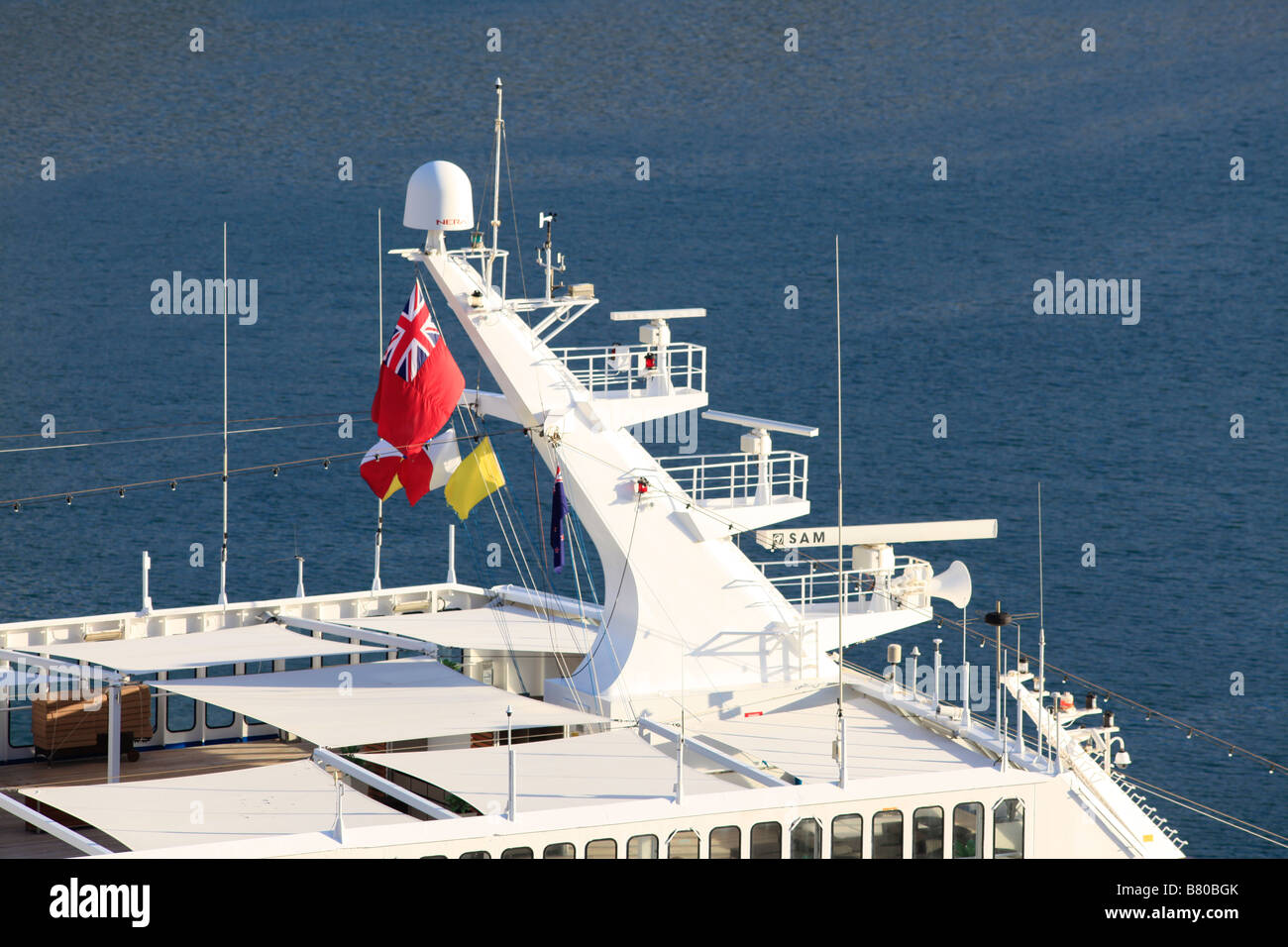 Pacific sun cruise ship's radar tower with three radars and flying P&O flag and red Ensign with a blue sea background Stock Photo