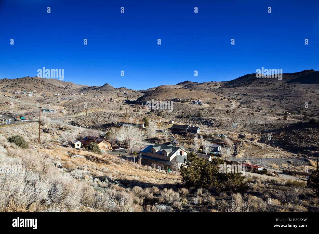 The town of Silver City Nevada with houses and buildings nestled between rolling hills south of Virginia City NV Stock Photo