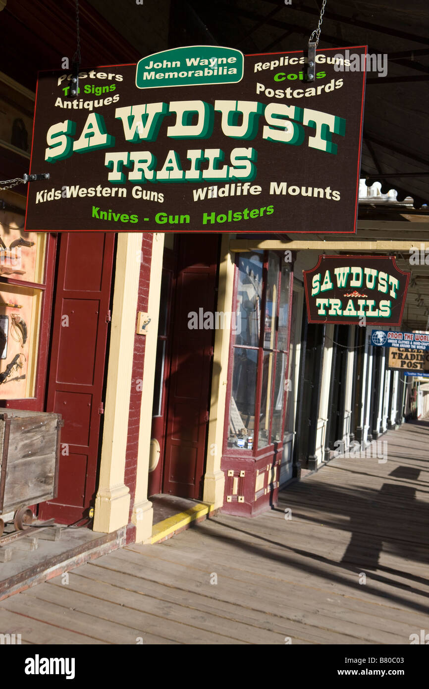 Shops with hanging signs and a wooden boardwalk side walk line Main Street Virginia City Nevada Stock Photo