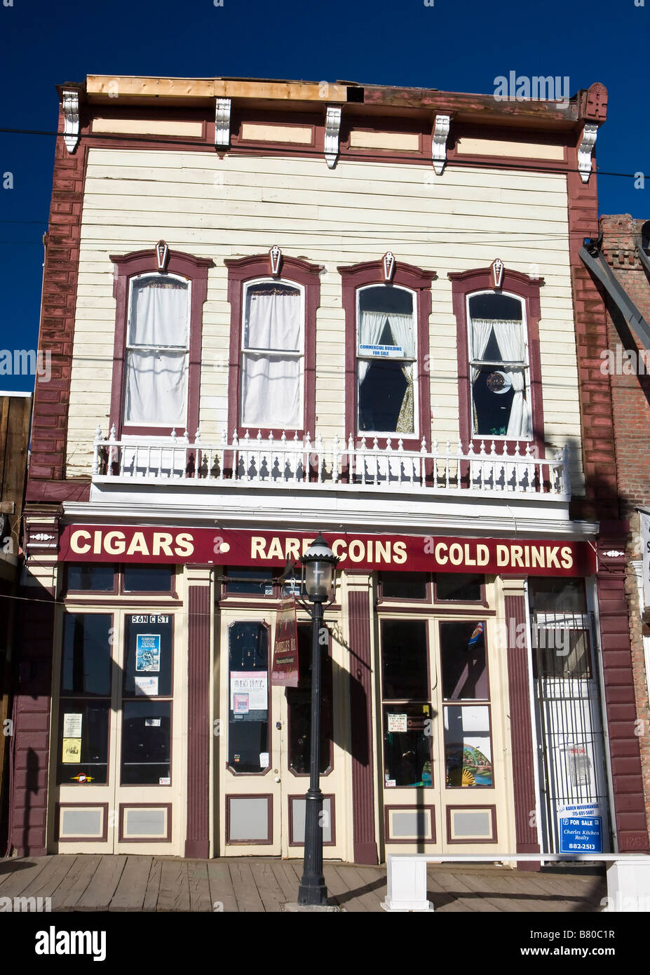 Shops with hanging signs and a wooden boardwalk side walk line Main Street Virginia City Nevada Stock Photo