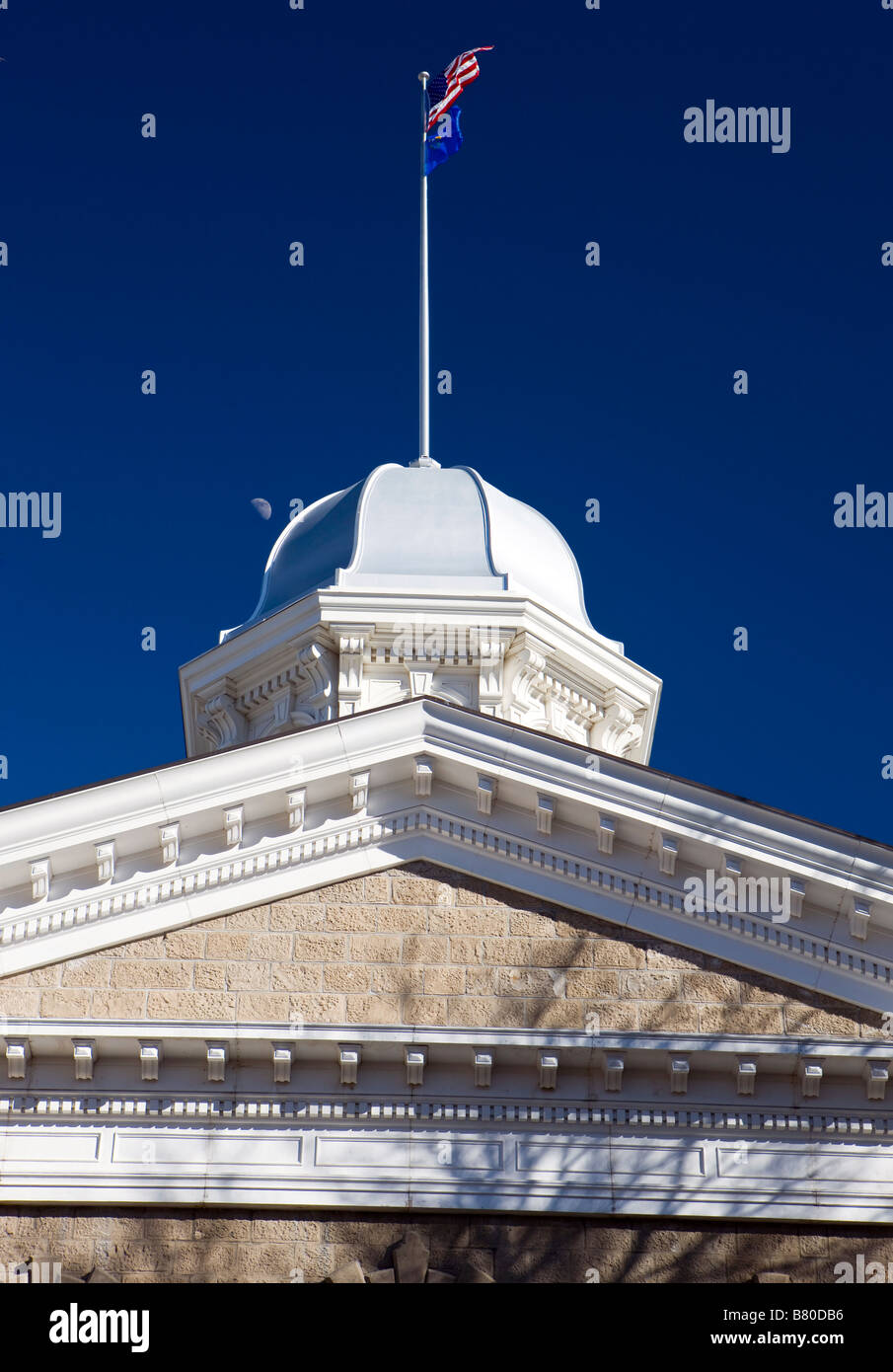 The dome of the Nevada State Capitol building Carson City NV with American and Nevada flags flying Stock Photo