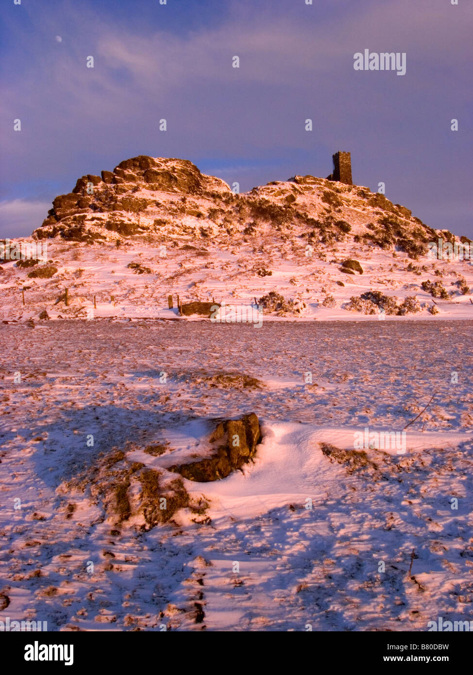St Michaels Church on Brentor in the winter snow in February 2009 at sunset Stock Photo