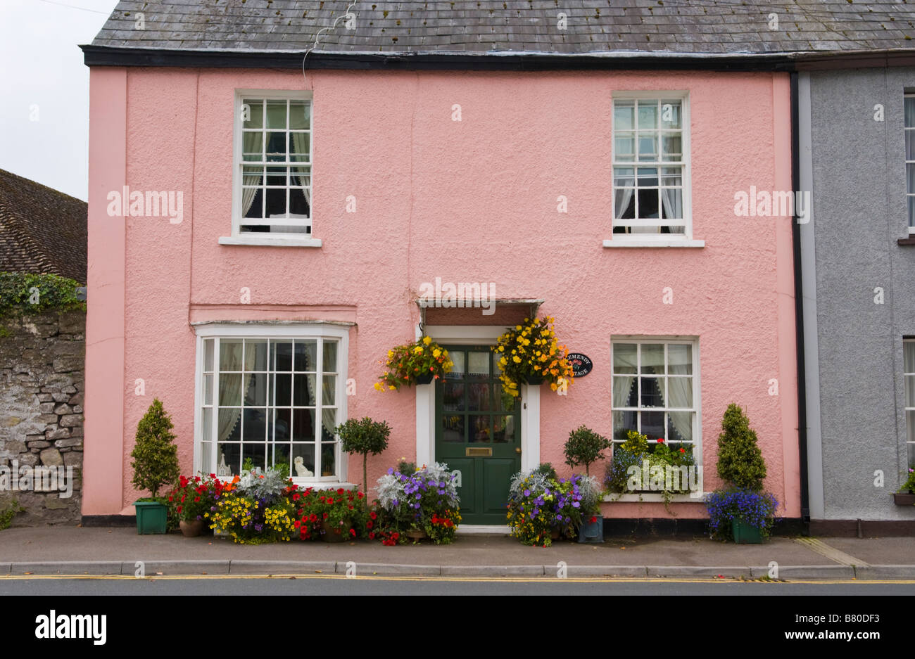 Typical rural town cottage with floral display outside in Usk